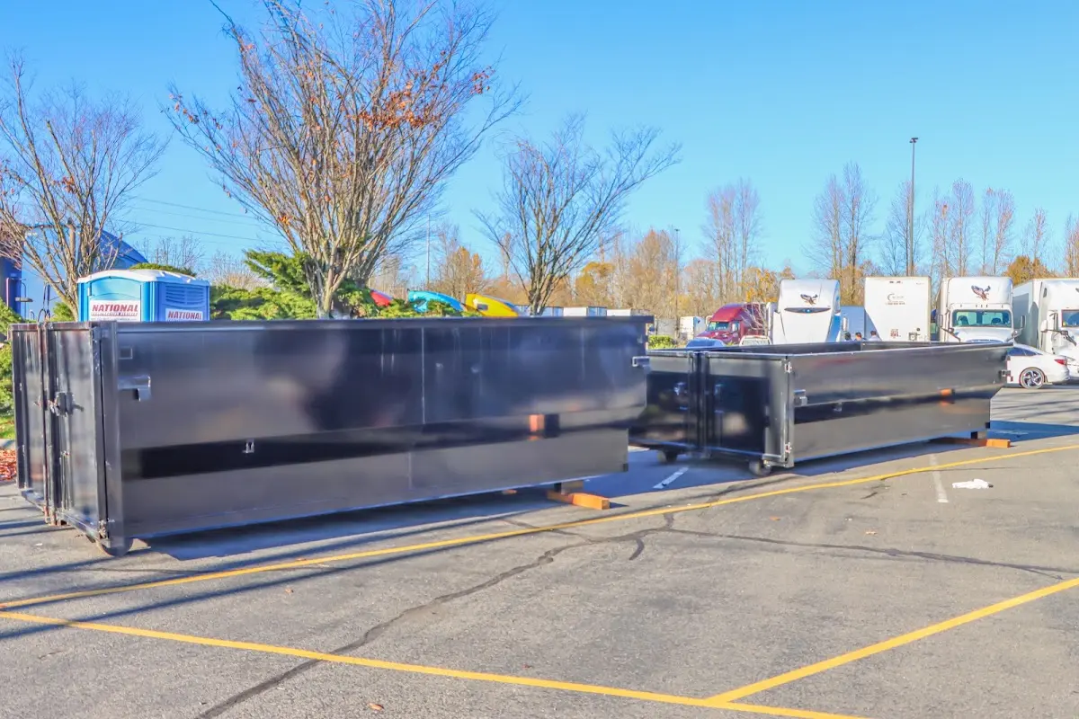 Professional dumpster rental service with roll-off container on residential driveway in Fort Valley